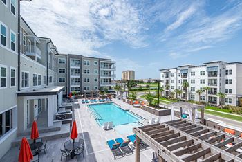 Sparkling resort style pool with lounge chairs to soak up the sun